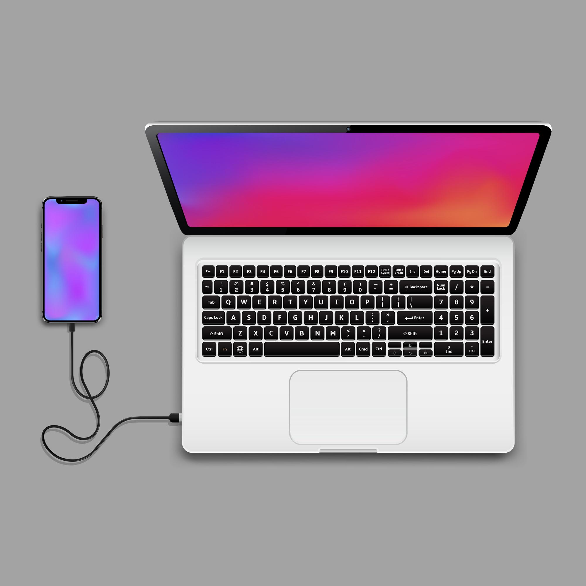 Un dispositivo móvil conectado a un ordenador.