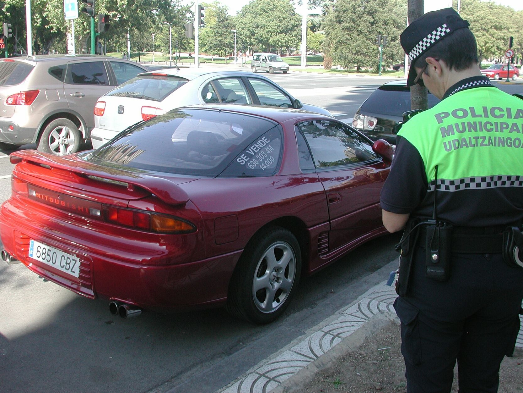 Municipal multando a un coche en venta.