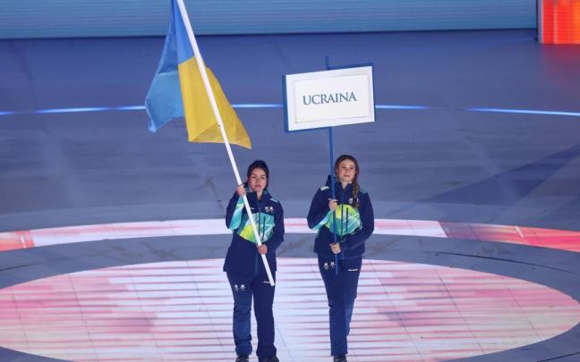 Una deportista porta la bandera de Ucrania en la ceremonia de apertura de los Juegos Paralímpicos de Milán-Cortina