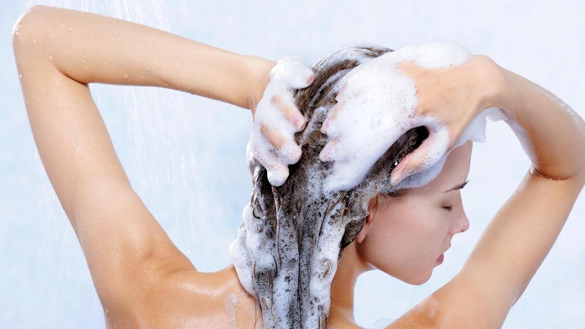 Una mujer con el cabello lleno de espuma.