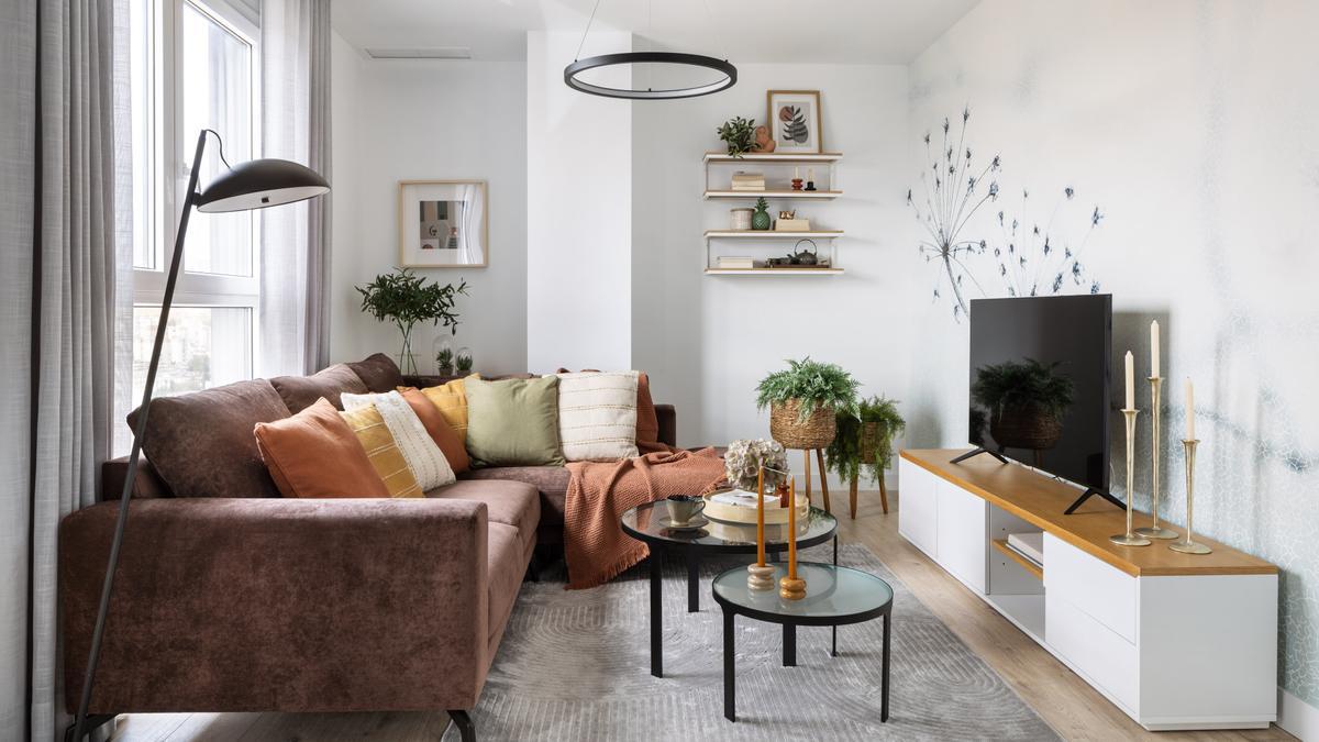 El salón, con un vistoso sofá lleno de cojines.