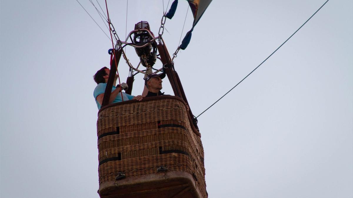 Un hombre subido en la cesta de un globo.