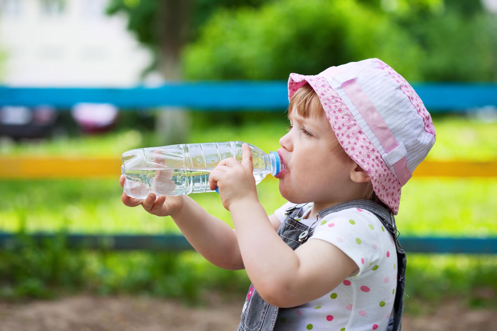 Niña bebe agua.