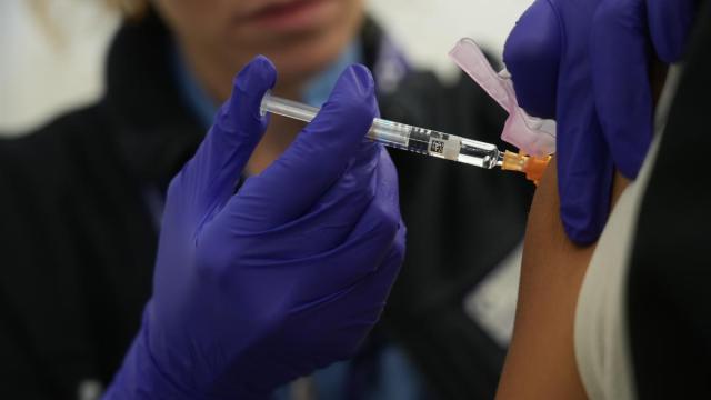 Una persona se vacuna en un centro de refuerzo de vacunación frente a la gripe