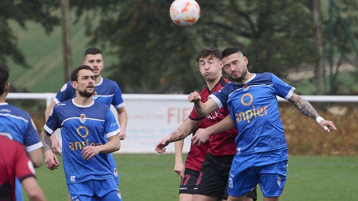 Los jugadores de la Peña Sport luchan por la posesión del balón durante un partido de Tercera RFEF