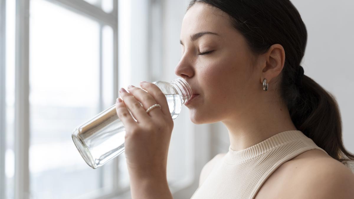 Mujer bebiendo agua.