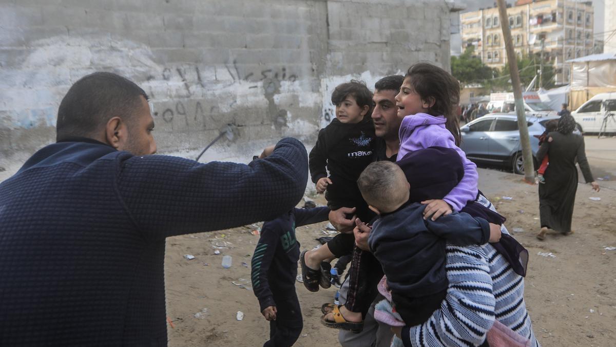 Una familia huye de los bombardeos israelíes sobre Rafah.