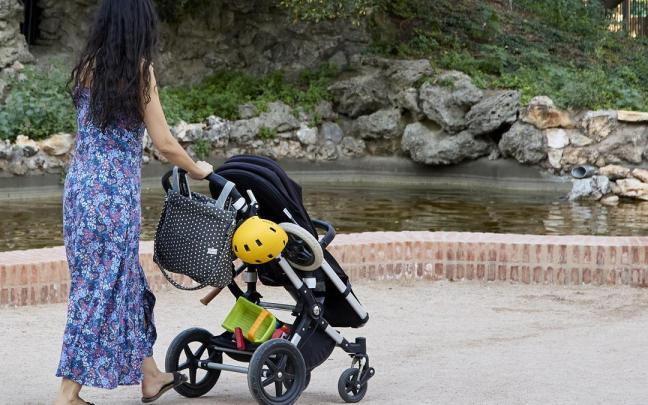 Una persona pasea con un carrito de bebé.