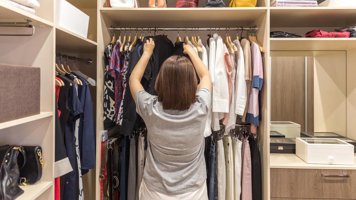 Una mujer ordena un armario.