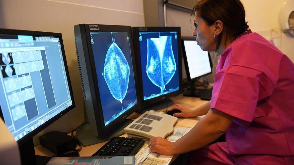 Una médico evalúa una mamografía.