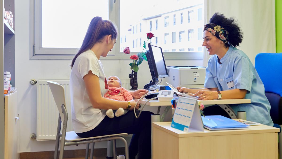 Una joven con un recién nacido en una consulta de Osakidetza.