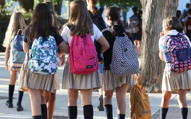 Varias niñas, a la entrada del colegio.