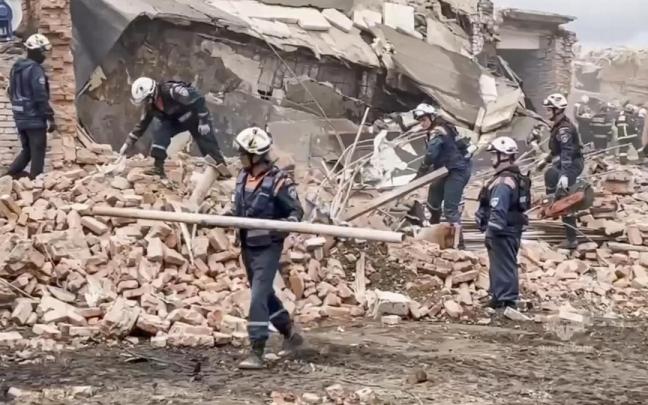 Personal de Emergencias de Rusia trabajando entre los escombros del almacén tras la explosión.