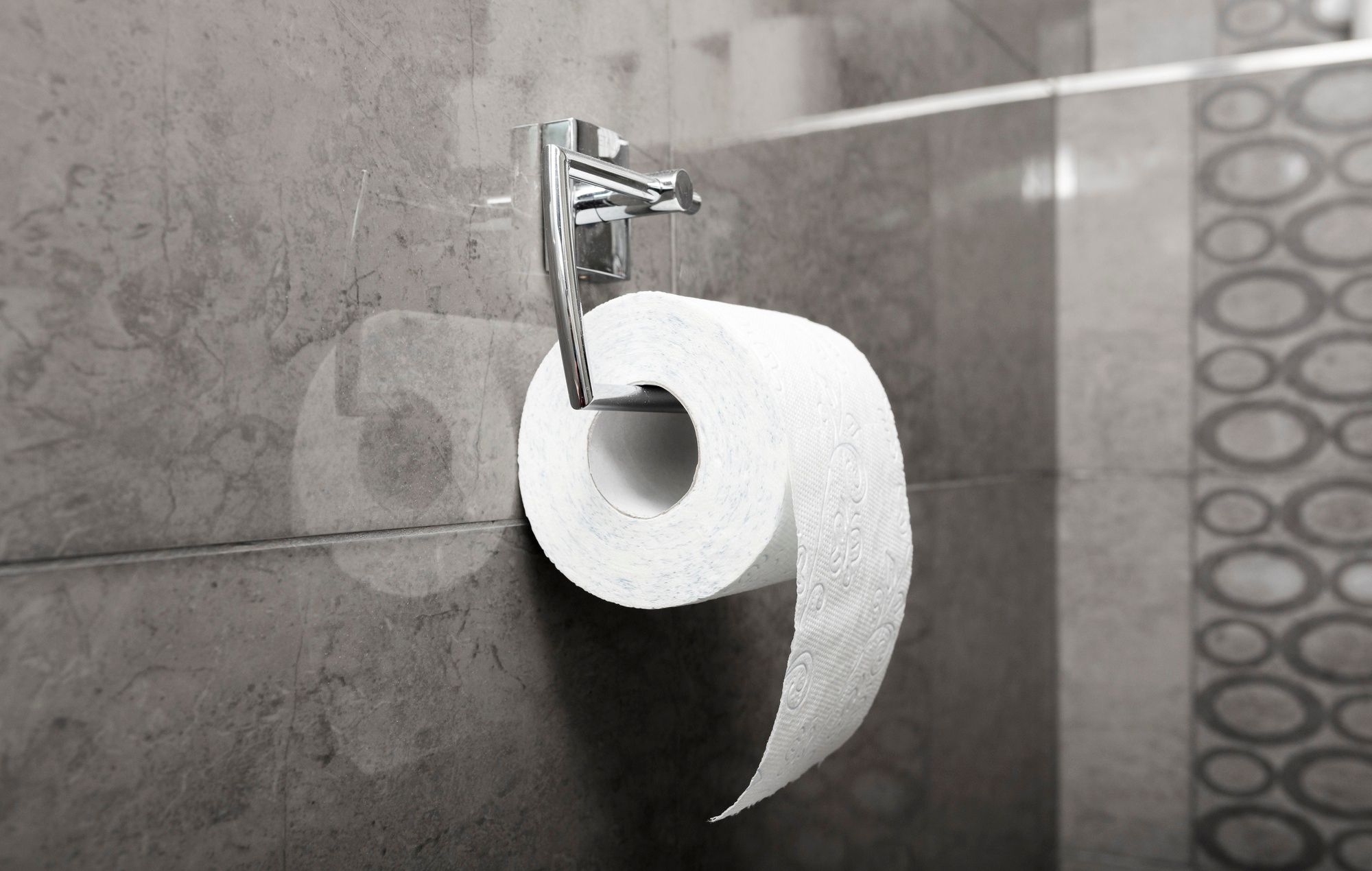 Un rollo de papel higiénico cuelga de un portarrollos en la posición correcta.