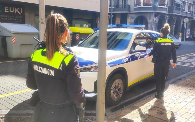 Dos agentes de la Policía Municipal de la villa armera se dirigen al coche estacionado junto a la casa consistorial.