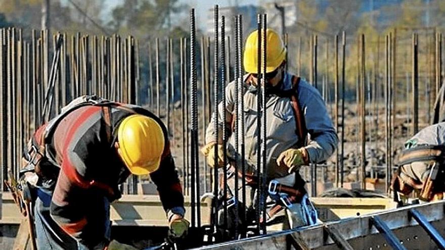 Un grupo de obreros trabajan en la construcción de un edificio.