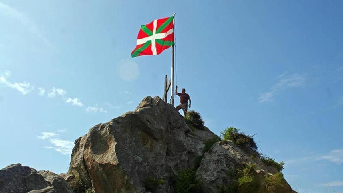 Imagen de una ikurriña en lo alto de una montaña