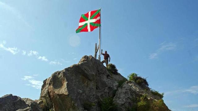 Imagen de una ikurriña en lo alto de una montaña / Carlos Zárate Imagen de una ikurriña en lo alto de una montaña