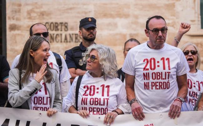 Varias personas con pancartas, durante una concentración para pedir la dimisión de Mazón