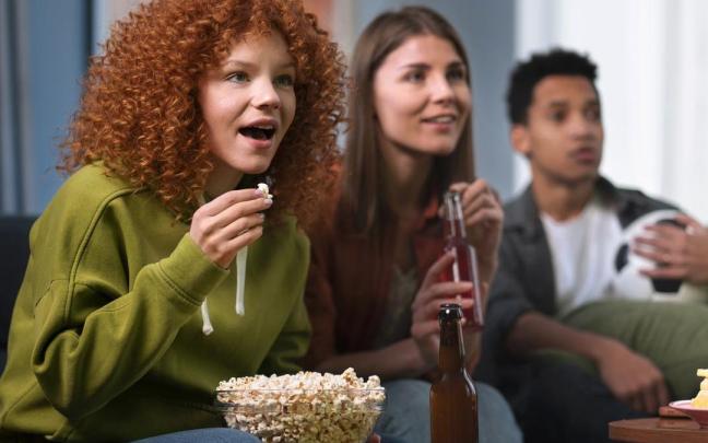 Personas comiendo palomitas, en una imagen de archivo.