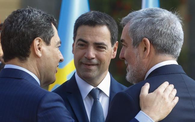 Pradales charla con el presidente de Andalucía, Juanma Moreno (i), y el de Canarias, Fernando Clavijo (d) en el encuentro en Barcelona.