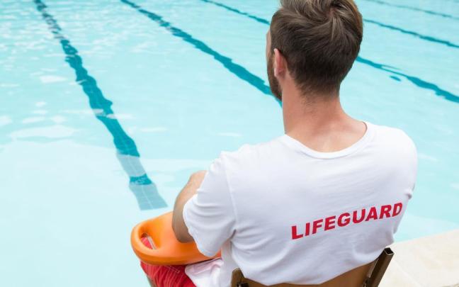 Un socorrista vigila una piscina.