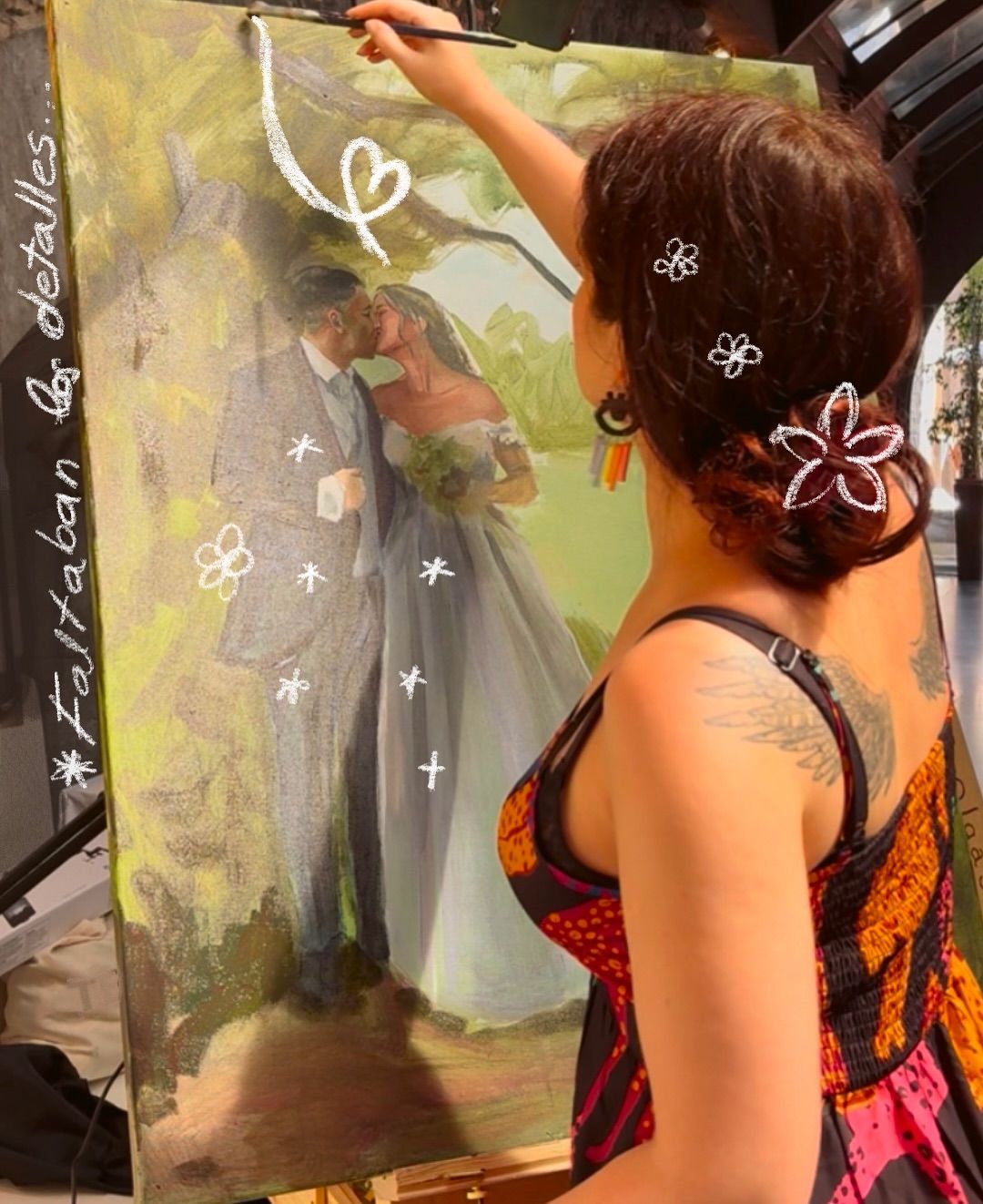 La artista Olga Santisteban dibujando el cuadro en la boda