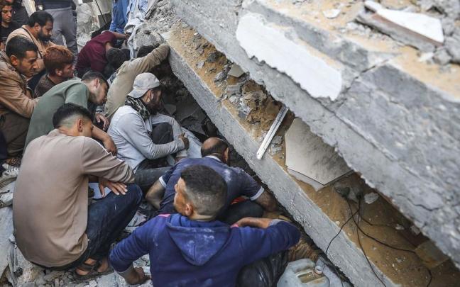 Palestinos buscan supervivientes tras un ataque aéreo israelí en el campo de refugiados de Jabalia, en el norte de Gaza.