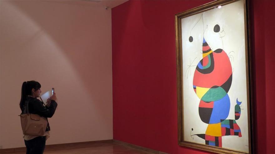Una joven observa un cuadro de Joan Miró