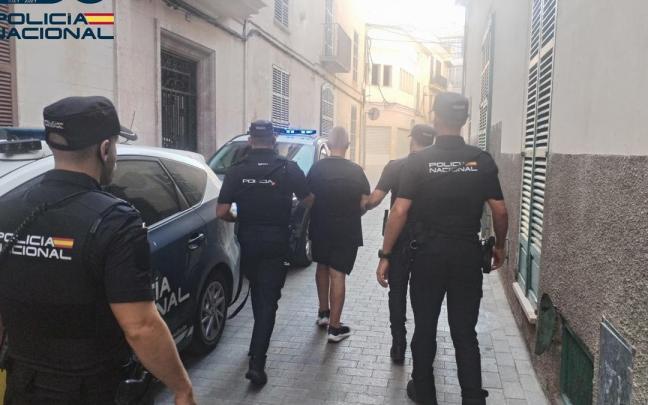 El detenido, de espaldas, escoltado por varios agentes de la Policía Nacional.