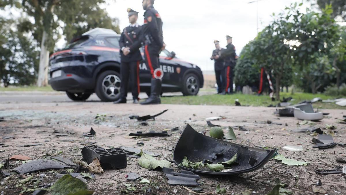 Varios agentes de los Carabineros italianos junto a los restos del coche del periodista Sigfrido Ranucci.