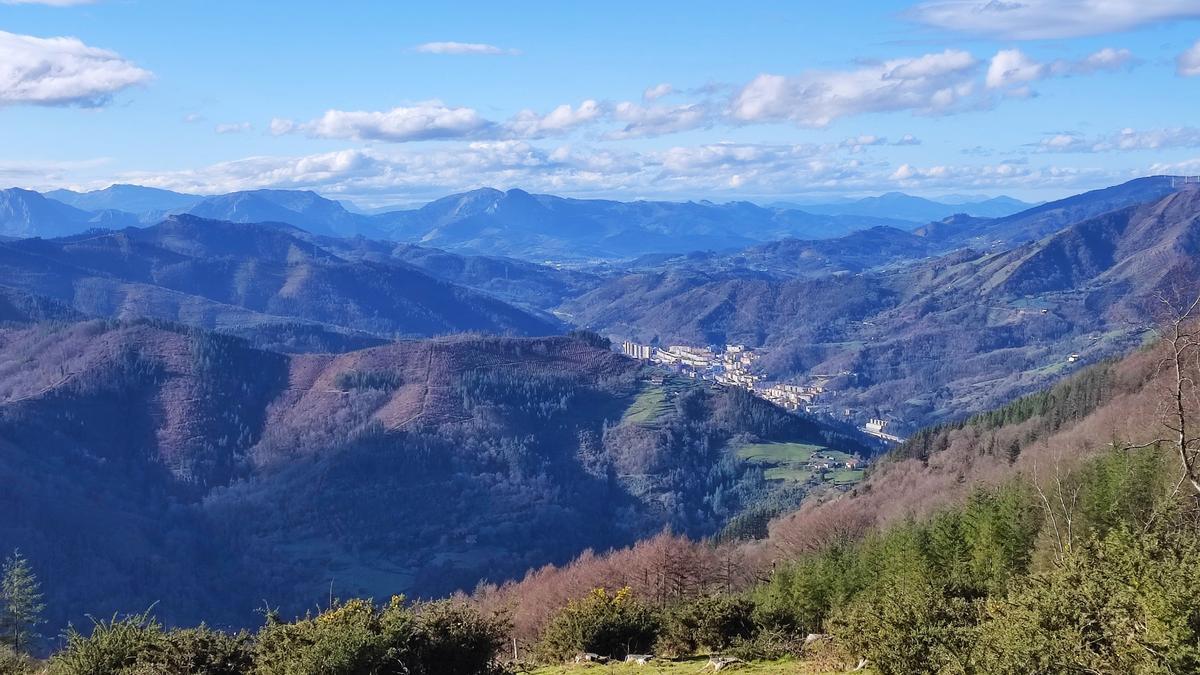Vista, en primer plano, de la zona en la que se plantea instalar el parque eólico de Basalgo, con la localidad de Eibar al fondo.