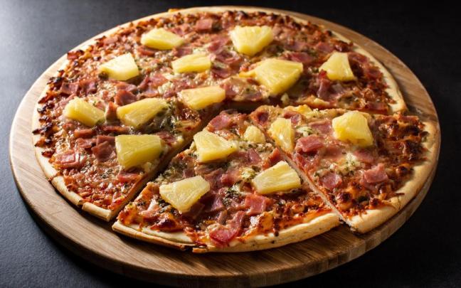 Una pizza hawaiana con su piña. / Freepik Una pizza hawaiana con su piña.