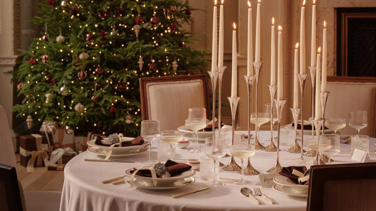 Elegante mesa de Navidad con velas a distintas alturas.