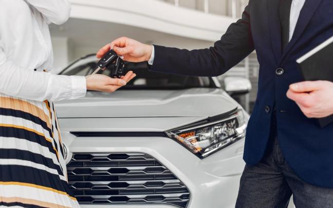 Persona recibiendo las llaves de un coche después de haberlo comprado. Persona recibiendo las llaves de un coche después de haberlo comprado.