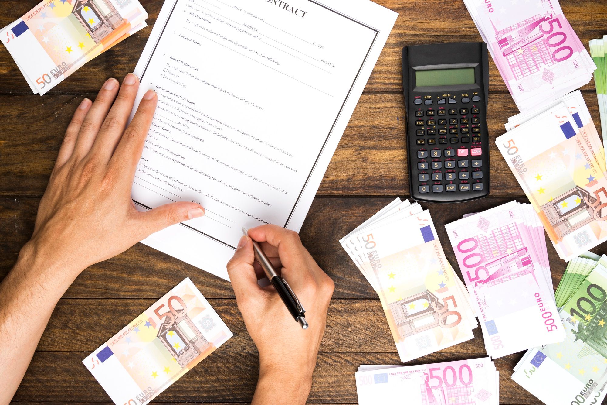 Un hombre firma el contrato de un préstamo bancario.