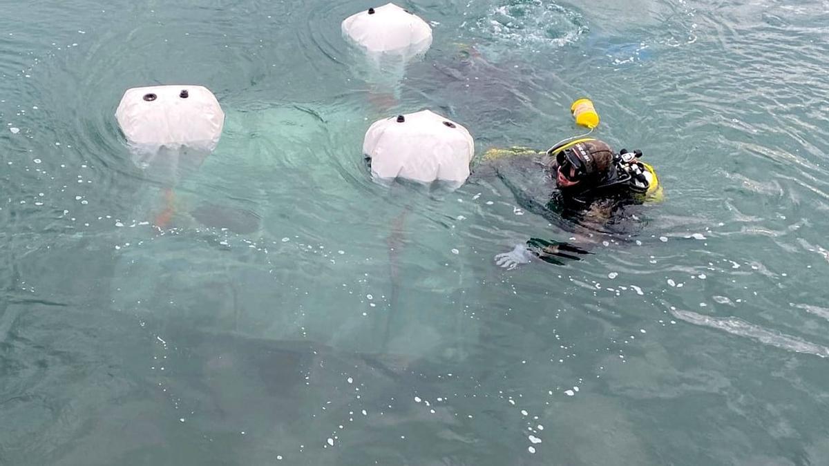 Un submarinista rescatando la escultura 'Zinka'.