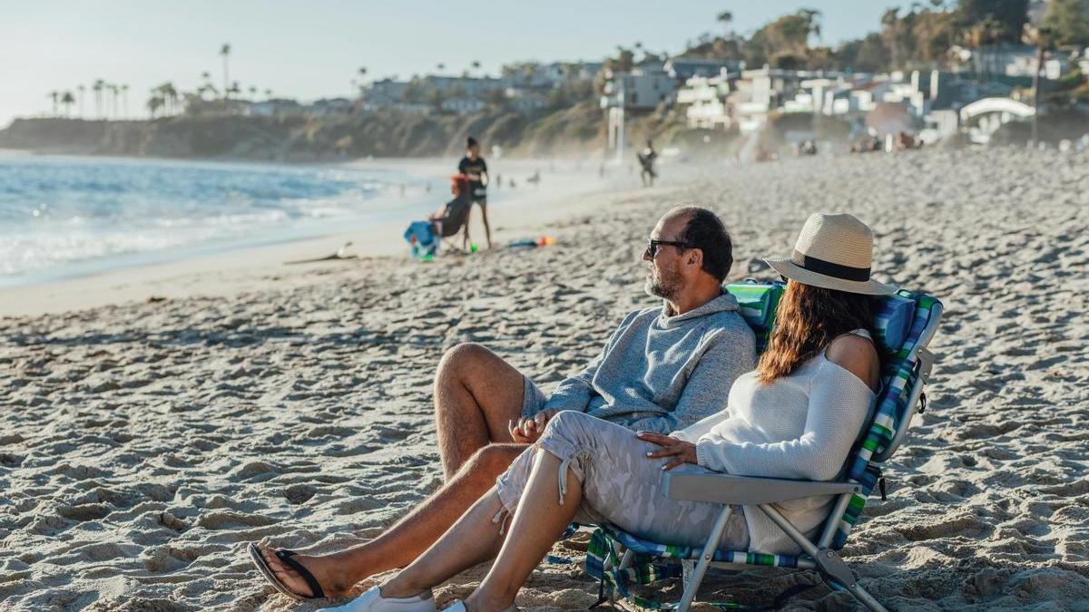 Pareja con sus sillas mientras disfrutan de la playa