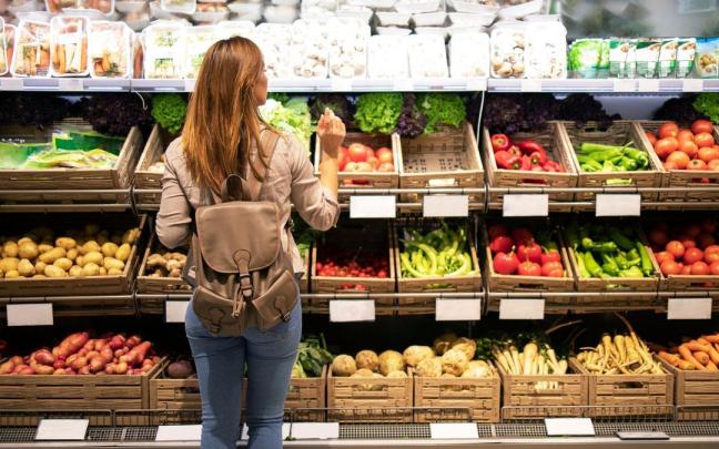Una mujer hace la compra en un supermercado. Una mujer hace la compra en un supermercado.