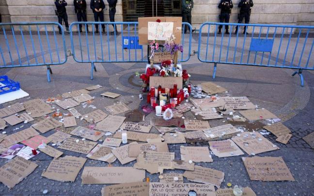 Mensajes, velas y flores en recuerdo de Maricarmen en la acampada de la Puerta del Sol