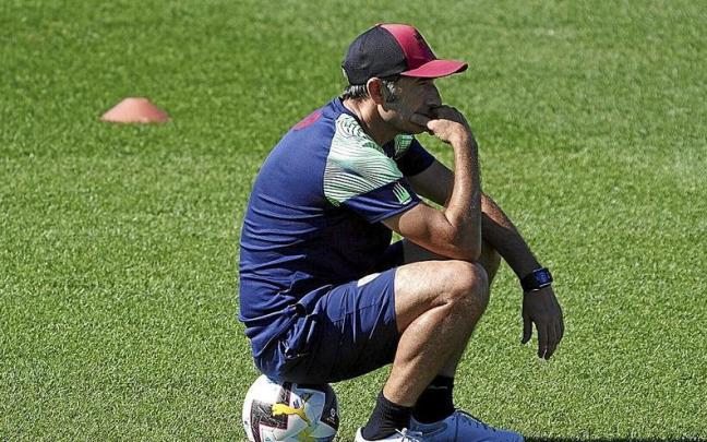 Ernesto Valverde, sentado sobre un bal&oacute;n, mientras observa un entrenamiento de sus futbolistas en Lezama. | FOTO: OSKAR M. BERNAL