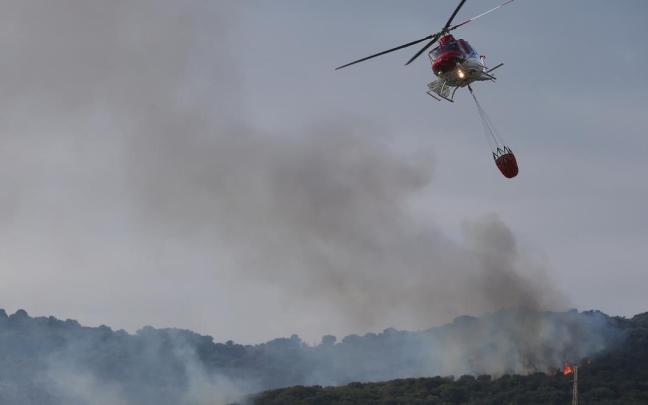 Un helicóptero trabaja en la extinción del incendio de Algeciras (Cádiz). Un helicóptero trabaja en la extinción del incendio de Algeciras (Cádiz).