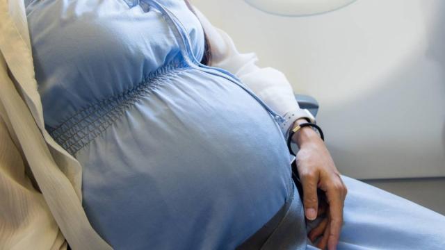 Mujer embarazada viaja en avión.