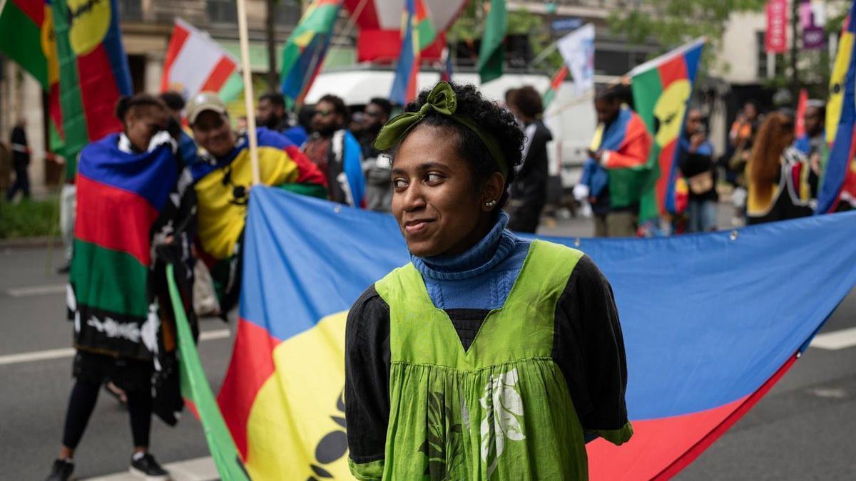 Una joven lleva una bandera de Nueva Caledonia durante una protesta en París el pasado año