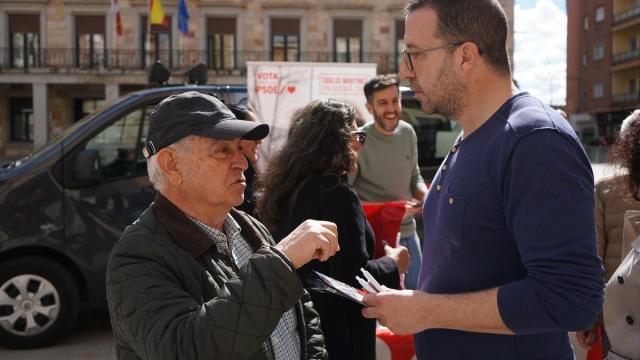 El secretario de Organización del PSOE de Zamora, Iñaki Gómez, atiende a un ciudadano durante la campaña electoral en Castilla y León.