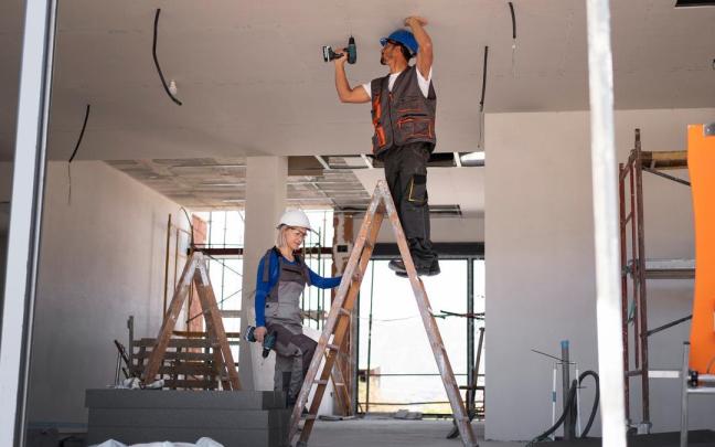 Dos trabajadores durante la reforma integral de una vivienda.