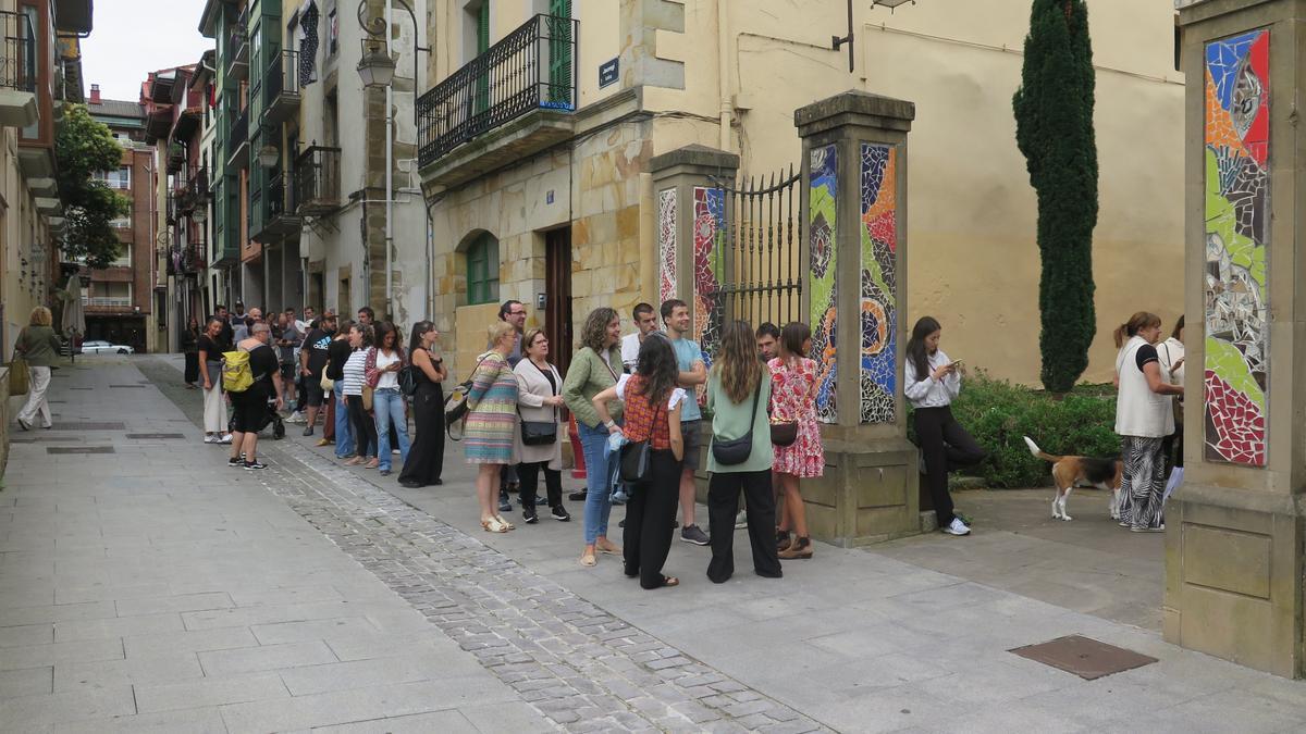 Urretxuarras haciendo cola para comprar los tique de la comida.