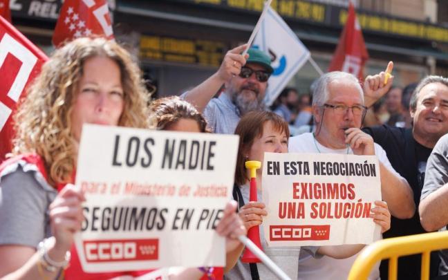 Funcionarios de justicia sujetan pancartas durante una concentración frente al Ministerio.