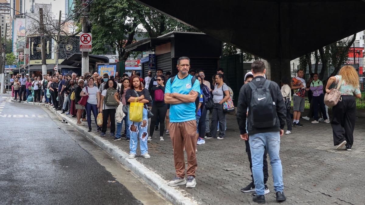 Ciudadanos brasileños esperan en una parada de autobús abarrotada este domingo, debido a la demora de los vehículos durante la segunda vuelta de las elecciones en Brasil.