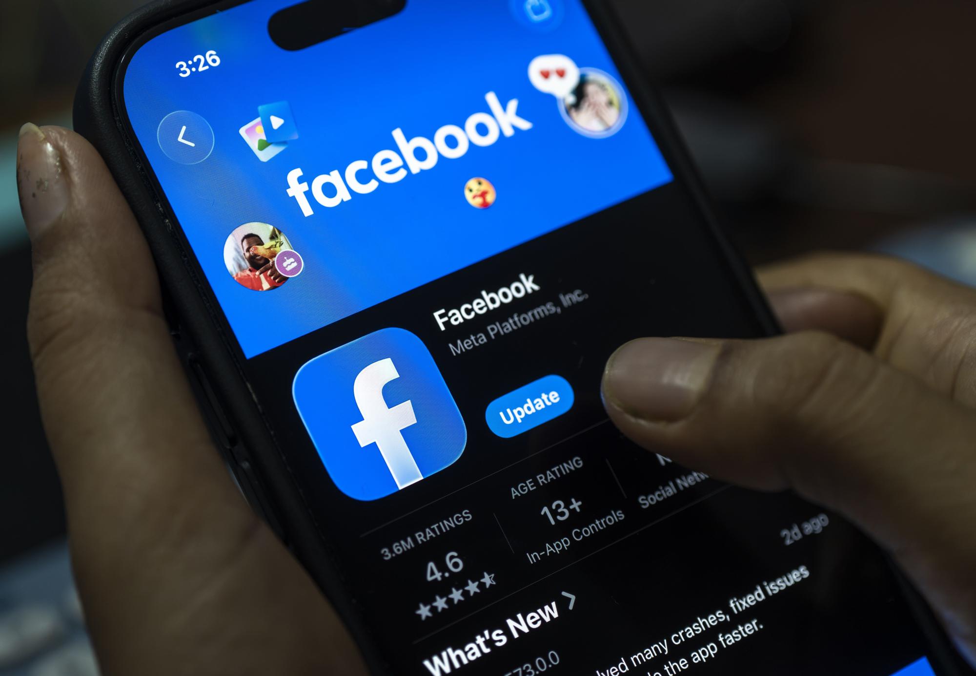 In this photo illustration, a person holds a smartphone displaying the Facebook app on the App Store, in New Delhi, India on 8 August 2026.
